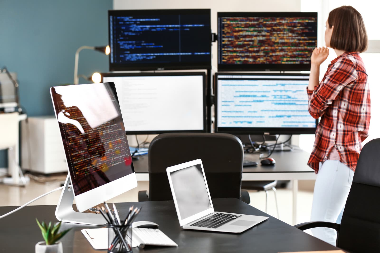 A workstation with multiple monitors in an office