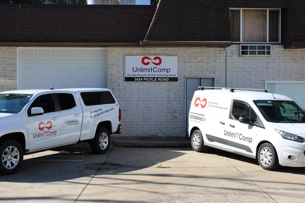 UnlimitComp service vans parked outside the company building